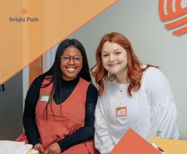 Person wearing headphones sitting at desk working on laptop